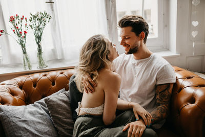 Young couple sitting at home