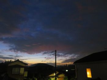 Low angle view of silhouette buildings against sky at dusk