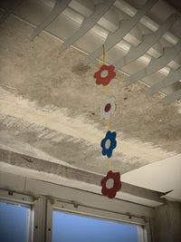 Low angle view of balloons hanging on building against sky