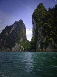 Scenic view of sea and mountains against sky