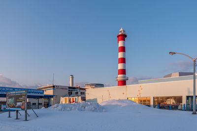 Lighthouse against clear sky during winter