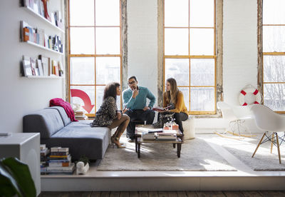 Business people sitting and discussing in creative office