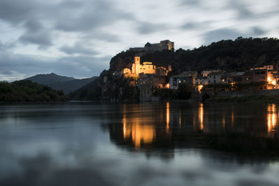 Miravet enlightened and beautiful town and its reflection on the river in catalonia 