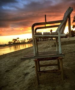 Lifeguard hut on beach against dramatic sky