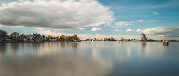 Buildings at waterfront in city against sky