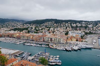 High angle view of townscape by sea against sky