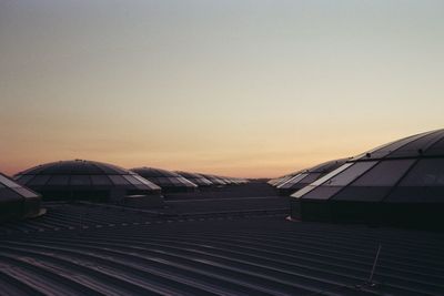 Roof of building against clear sky at sunset