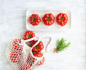 Still life of beautiful ripe tomatoes and rosemary.