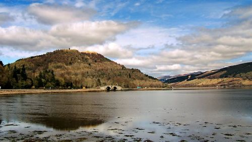 Scenic view of lake and mountains against sky