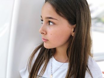 Close-up of girl looking away at home