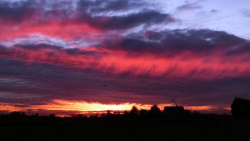 Silhouette of landscape against cloudy sky