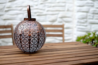 Close-up of antique container on wooden table