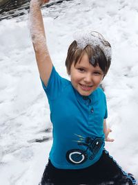 A little boy plays happily at a bubble fair 