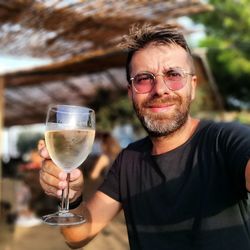 Portrait of smiling man with drink