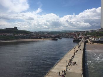 High angle view of sea and cityscape against sky