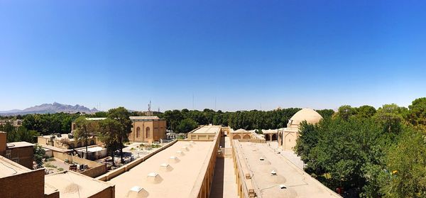 Panoramic view of trees against clear blue sky