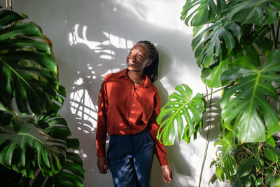 Young woman standing amidst plants