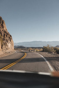 Empty road against clear sky