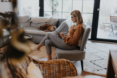 Woman sitting on sofa at home