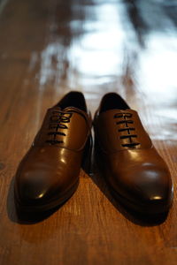 High angle view of shoes on wooden table