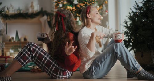 Rear view of woman sitting on sofa at home