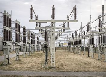 Row of metal fence against sky in city