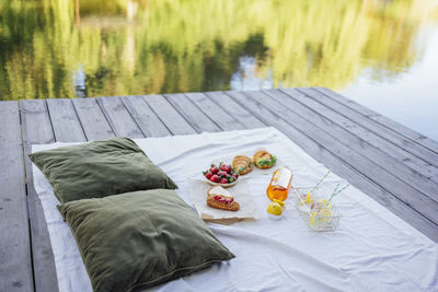 Low section of woman relaxing on bed