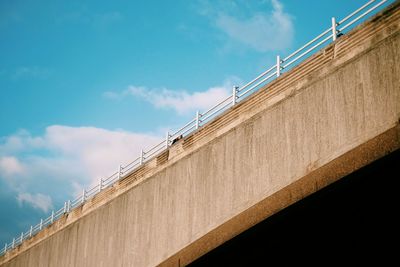 Low angle view of bridge against blue sky