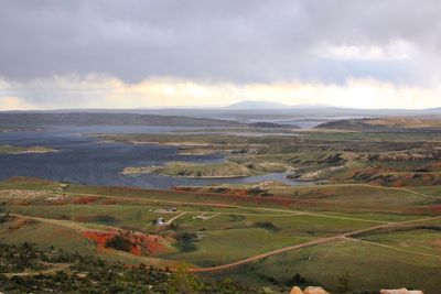 Scenic view of landscape against cloudy sky