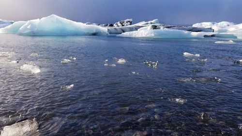 Scenic view of frozen lake against sky