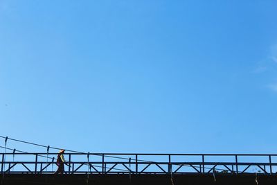 Low angle view of bridge against clear blue sky