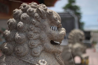 Close-up of statue against stone wall