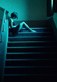 Woman sitting on stairs