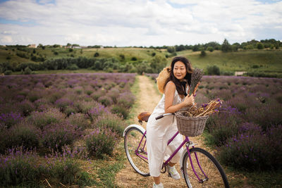 Asian woman with retro bike in lavender field