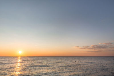 Sunrise on the sea with reflection on the water