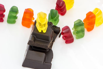 High angle view of multi colored candies against white background