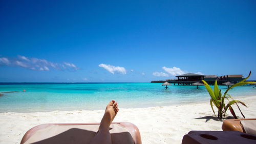 Low section of woman relaxing on beach