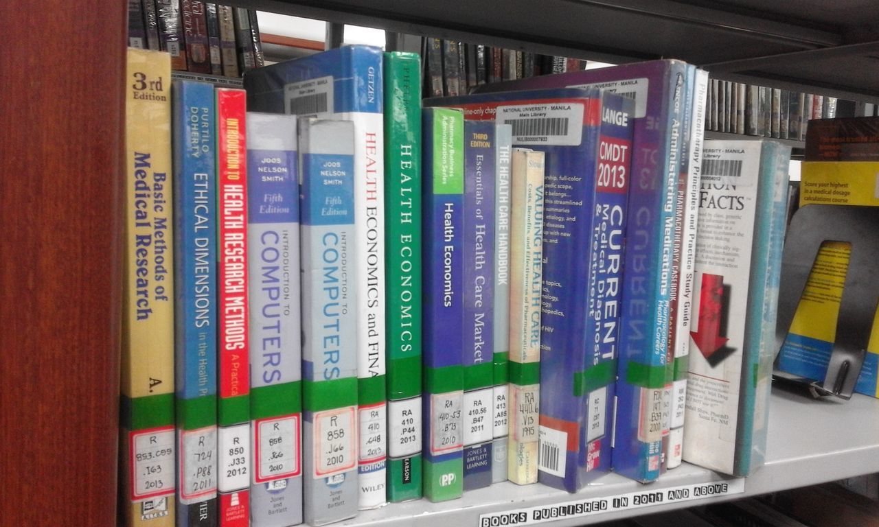 STACK OF BOOKS IN SHELF