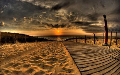 Scenic view of beach against sky during sunset