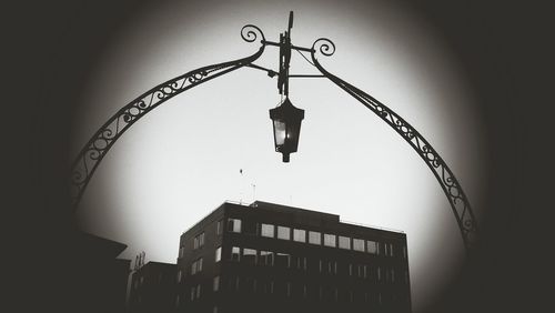 Low angle view of illuminated street light against sky