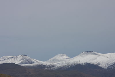 Scenic view of snowcapped mountains against clear sky