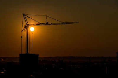 Silhouette of crane at sunset