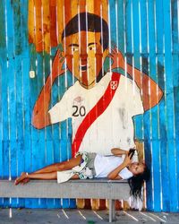 Portrait of young couple standing against built structure