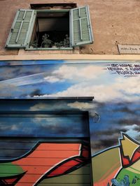 Low angle view of building against blue sky