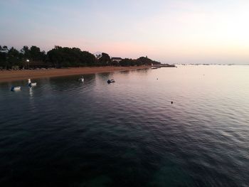 Scenic view of lake against sky at sunset