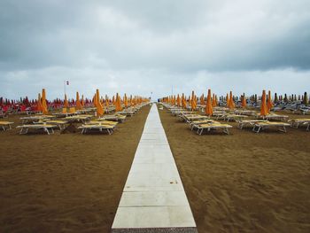 Panoramic view of wooden posts on beach against sky