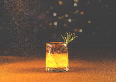 Low alcohol drink or aperol spritz in glass on bright background with sparkles. creative copy space.