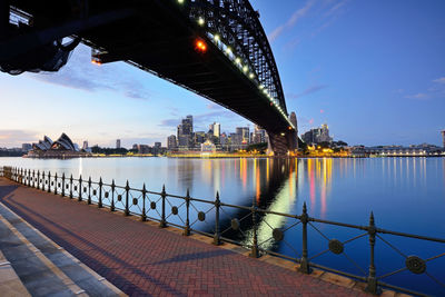 Bridge over river in city against sky