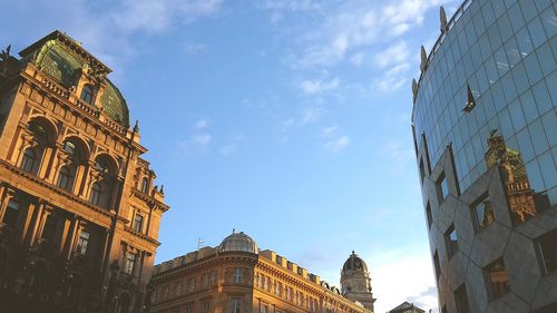 Reflection of historical building in glass building