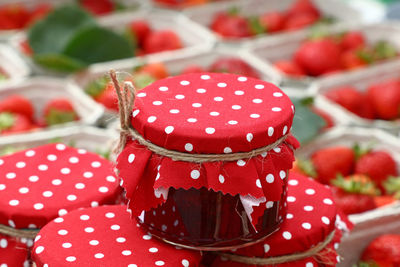 Close-up of jars by strawberries